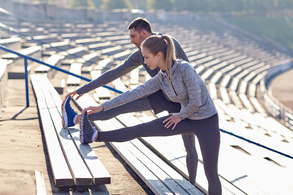 Fitness,,Sport,,Exercising,And,Lifestyle,Concept,-,Couple,Stretching,Leg