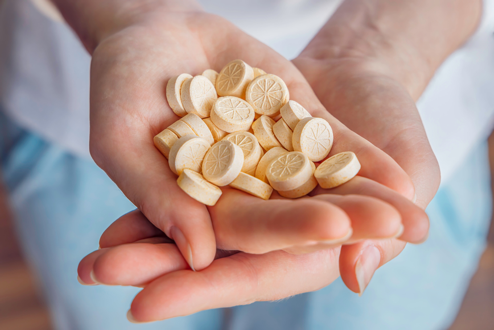 A,Woman,Holds,Vitamins,Pills,In,Her,Hands.,Vitamin,C