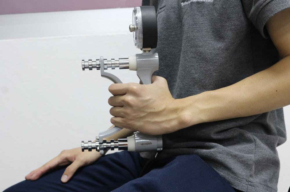 Man,Using,Grip,Strength,Dynamometer,For,Testing,Hand,Grip,Strength.