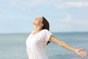 Relaxed,Woman,Breathing,Fresh,Air,And,Spreading,Stretching,Arms,On