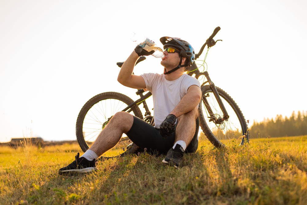 Young,Professional,Cyclist,Dressed,In,Cycling,Clothing,And,Protective,Helmet