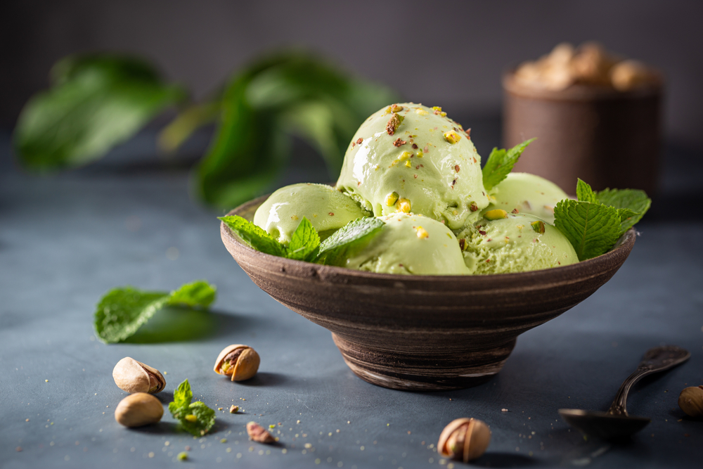 Homemade,Pistachio,Ice,Cream,Scoop,With,Chopped,Pistachios,On,Gray