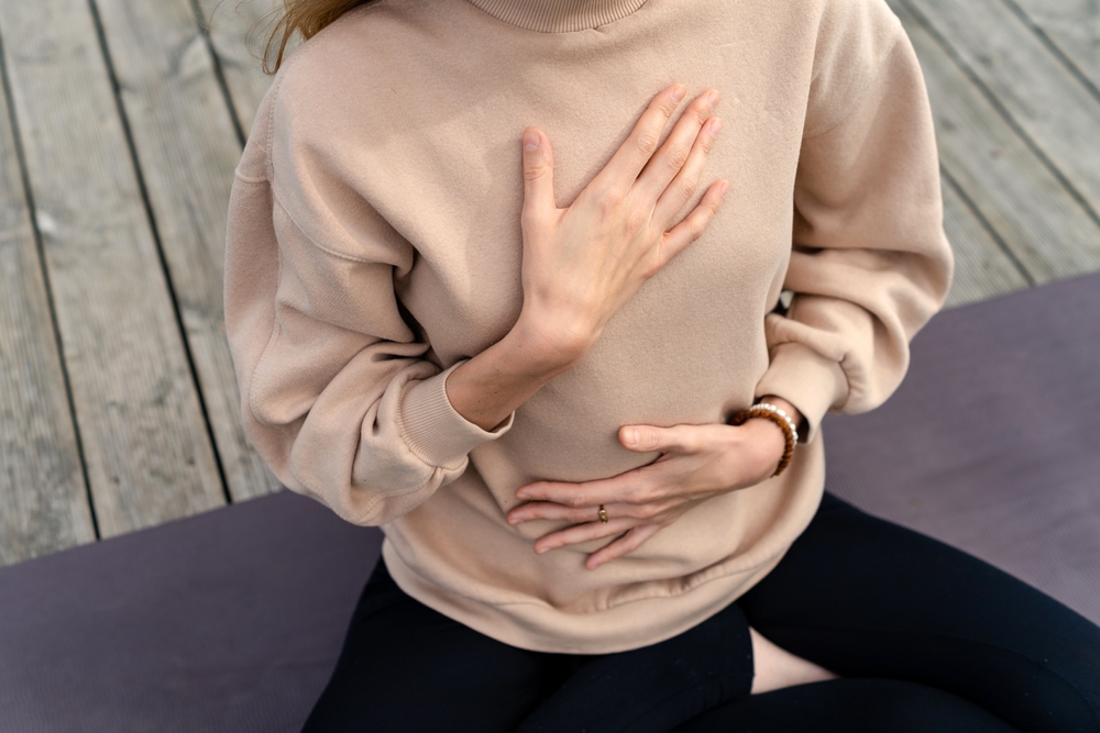 Close-up,Of,A,Woman's,Hands,On,Her,Chest,While,Doing