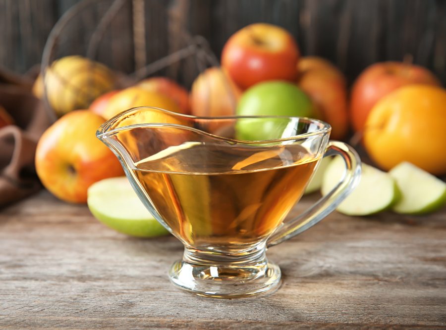 Glass,Gravy,Boat,With,Apple,Vinegar,And,Fresh,Fruit,On