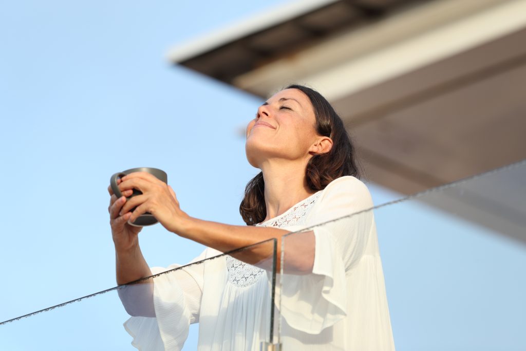 Satisfied,Adult,Woman,With,Coffee,Cup,Breathing,Fresh,Air,On