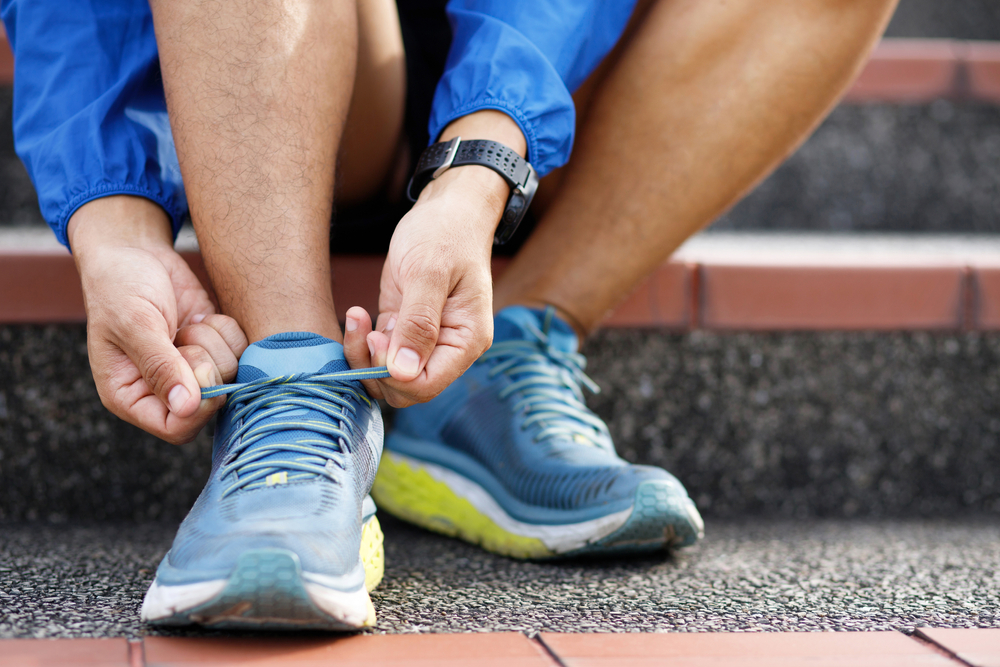 Running,Shoes.,Close,Up,Male,Sitting,On,Stair,Athlete,Tying