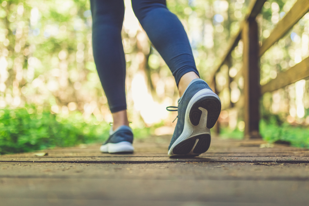 Woman,Runner,Feet,Walking,In,Nature.,Close,Up,On,Shoes.