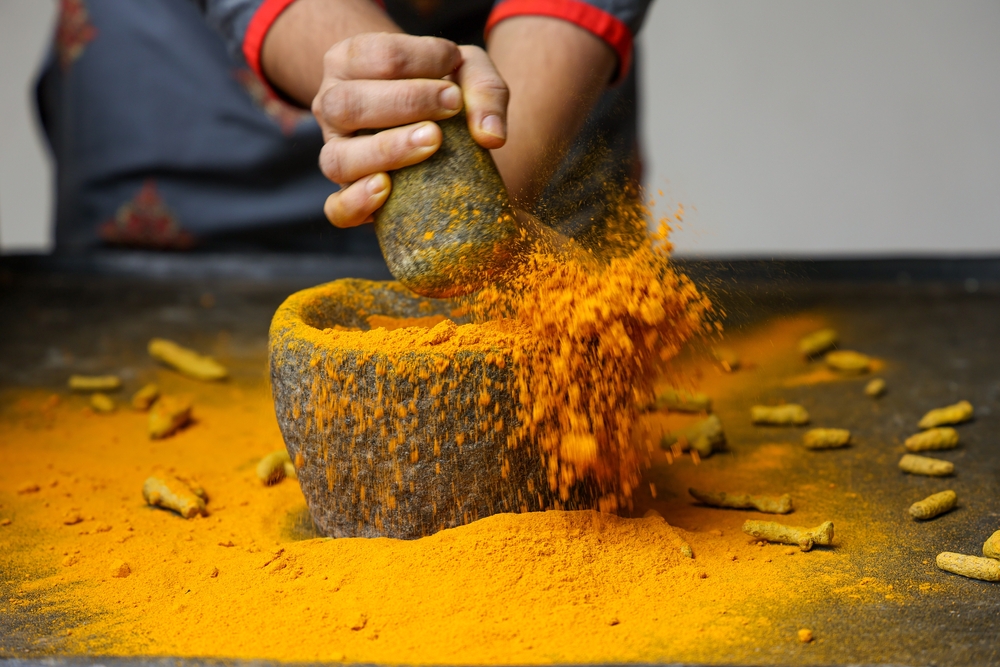 Woman,Hand,Powdering,Indian,Spices,Turmeric,Powder,Splash,Explosion,Stone