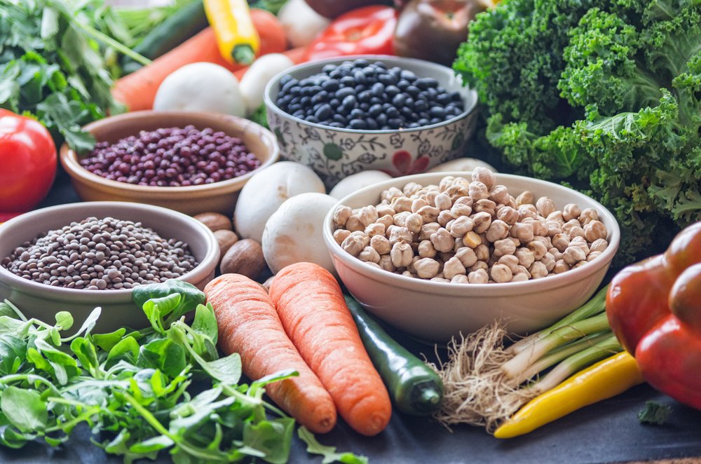 A,Table,With,Bowls,Of,Beans,And,Mixed,Vegetables